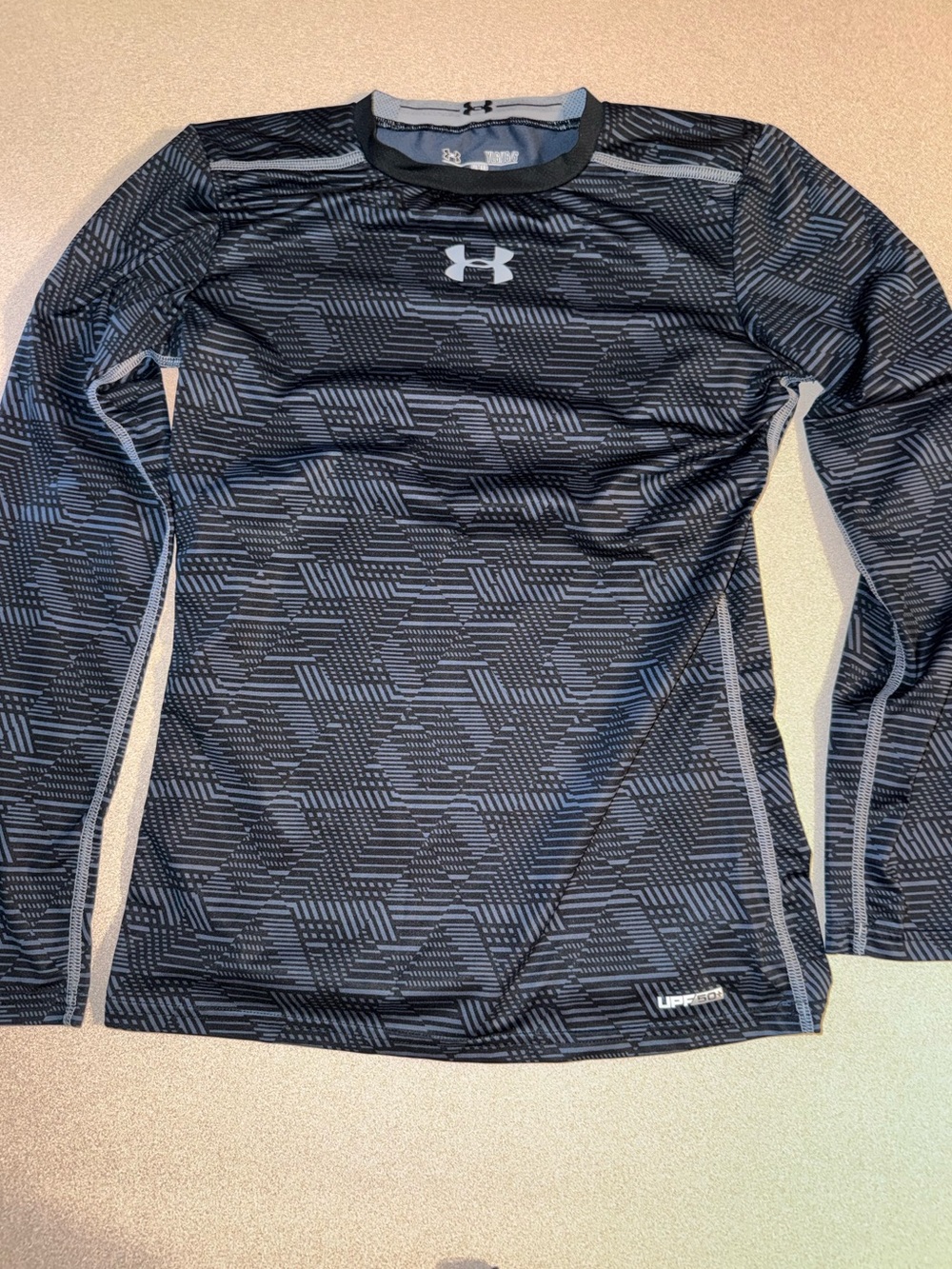Under Armour boys size YLG gray and black long-sleeve compression shirt with a g